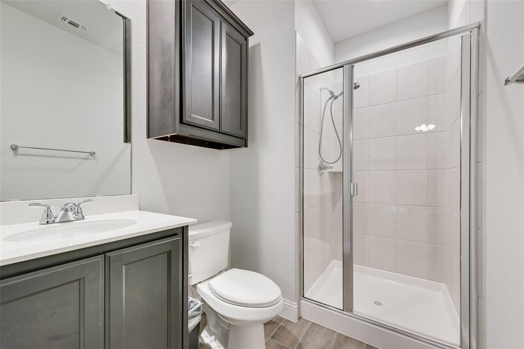 1279 Altuda Drive Forney, TX 75126 - Photo 15 of 35 a bathroom with a shower sink vanity mirror and toilet