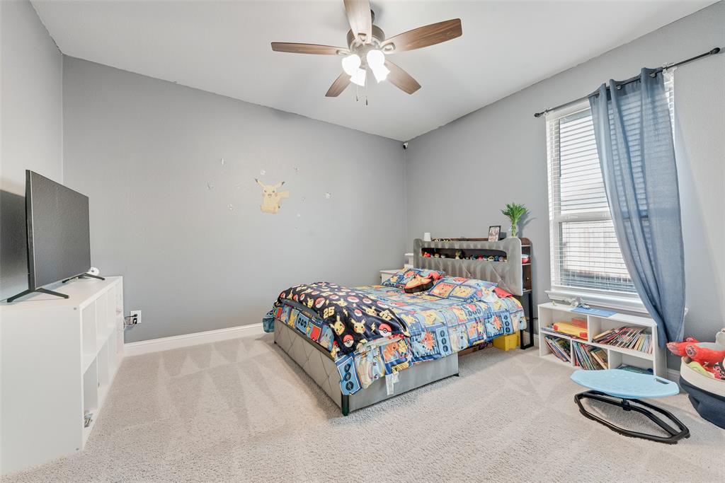 1279 Altuda Drive Forney, TX 75126 - Photo 16 of 35 a bedroom with a bed and a flat tv screen on dresser