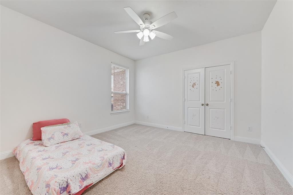 1279 Altuda Drive Forney, TX 75126 - Photo 18 of 35 a bedroom with a bed and a ceiling fan