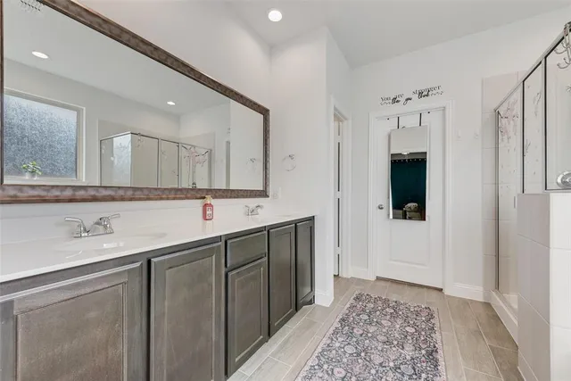 a spacious bathroom with a double vanity sink and a mirror