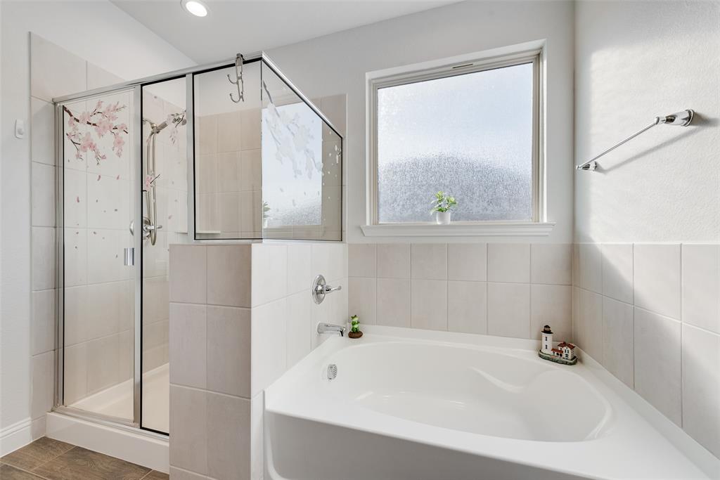 1279 Altuda Drive Forney, TX 75126 - Photo 22 of 35 a bathroom with a bathtub and a shower