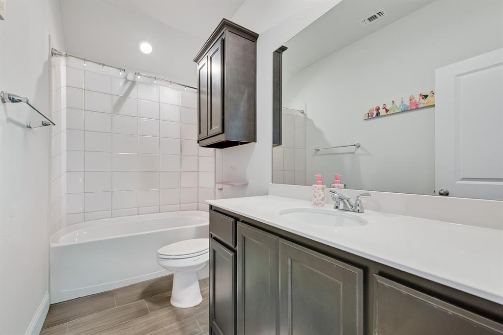 1279 Altuda Drive Forney, TX 75126 - Photo 25 of 35 a bathroom with a sink a toilet and shower