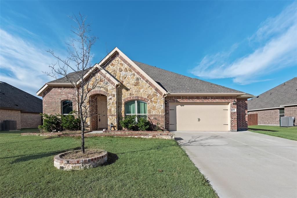 1279 Altuda Drive Forney, TX 75126 - Photo 3 of 35 a front view of a house with a yard and garage