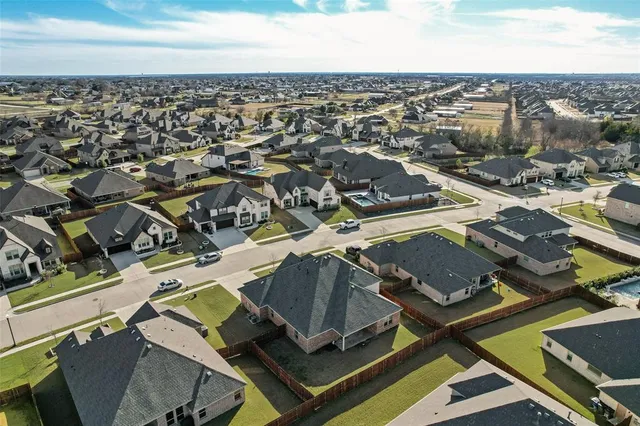 an aerial view of a residential building with parking space