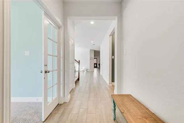 a view of a hallway with wooden floor