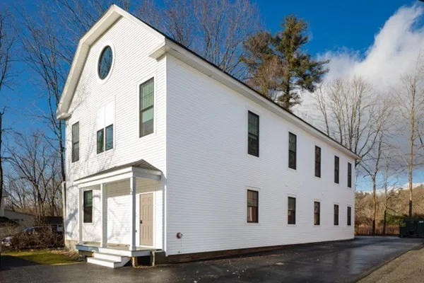 a view of a white building with a large windows