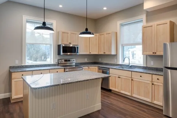 a kitchen with sink cabinets and wooden floor