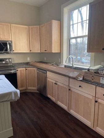 33 West Main Street, Unit A Groton, MA 01450 - Photo 4 of 10 a kitchen with sink cabinets and wooden floor