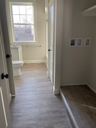 33 West Main Street, Unit A Groton, MA 01450 - Photo 5 of 10 an empty room with wooden floor and windows