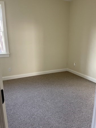 33 West Main Street, Unit A Groton, MA 01450 - Photo 7 of 10 an empty room with a window