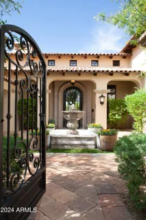 a front view of a house with a lots of flower plants