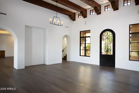 a living room with furniture fireplace and potted plants