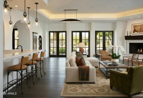 a view of lobby with chandelier and wooden floor