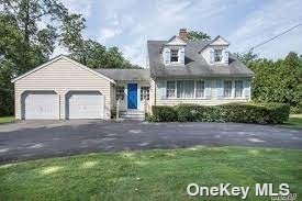 151 South Country Road Remsenburg, NY 11960 - Photo 1 of 1 a front view of a house with a garden