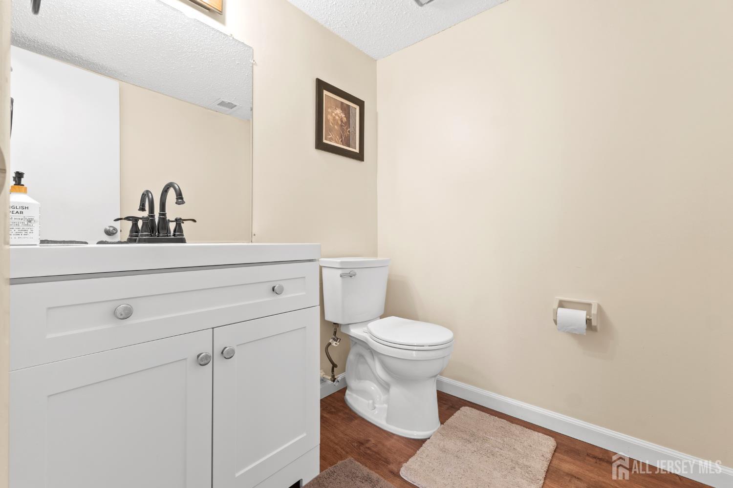 272 Westgate Drive Edison, NJ 08820 - Photo 18 of 47 a bathroom with a sink a toilet and a mirror