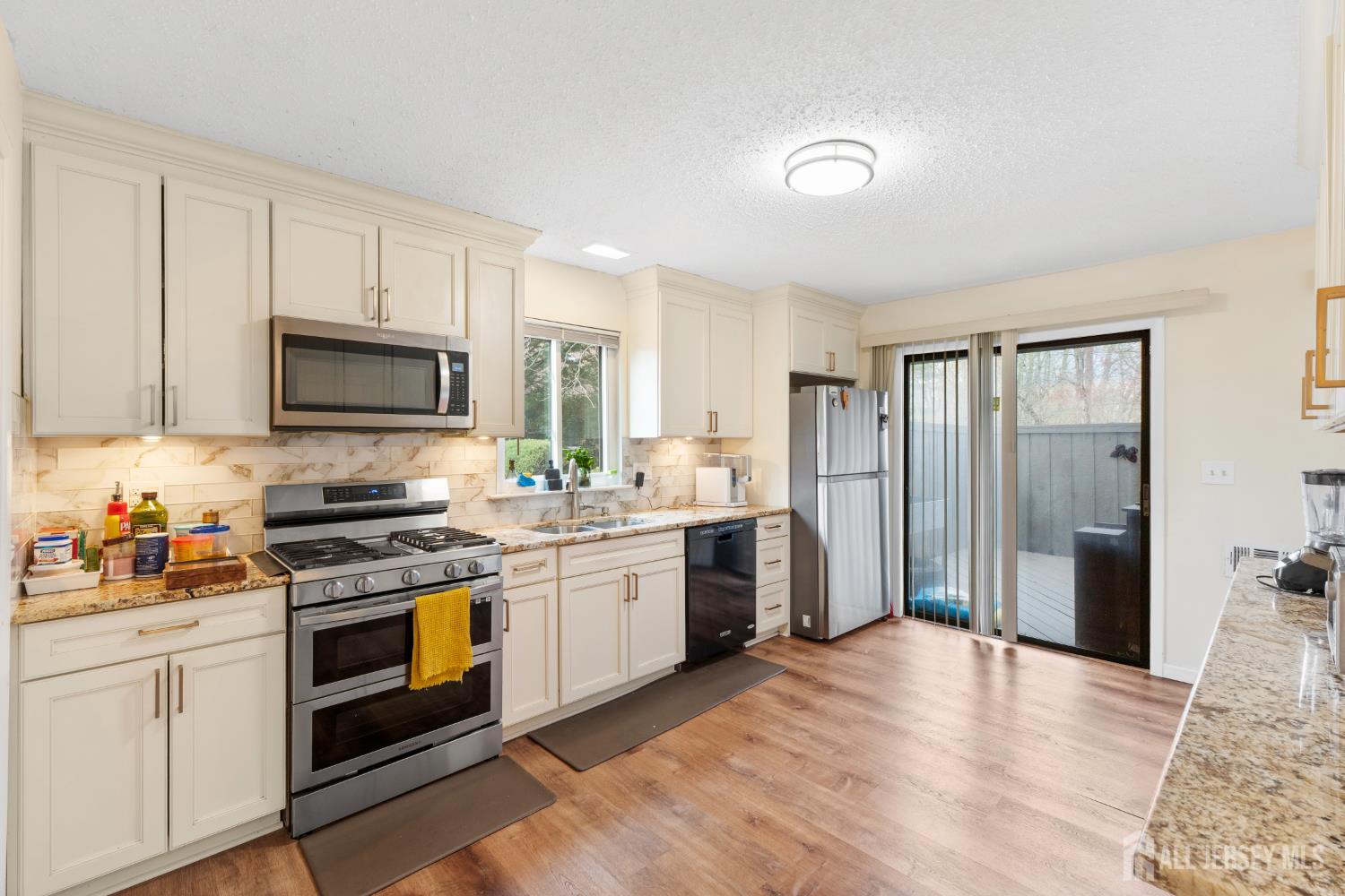 272 Westgate Drive Edison, NJ 08820 - Photo 21 of 47 a kitchen with stainless steel appliances granite countertop a stove a sink and a refrigerator