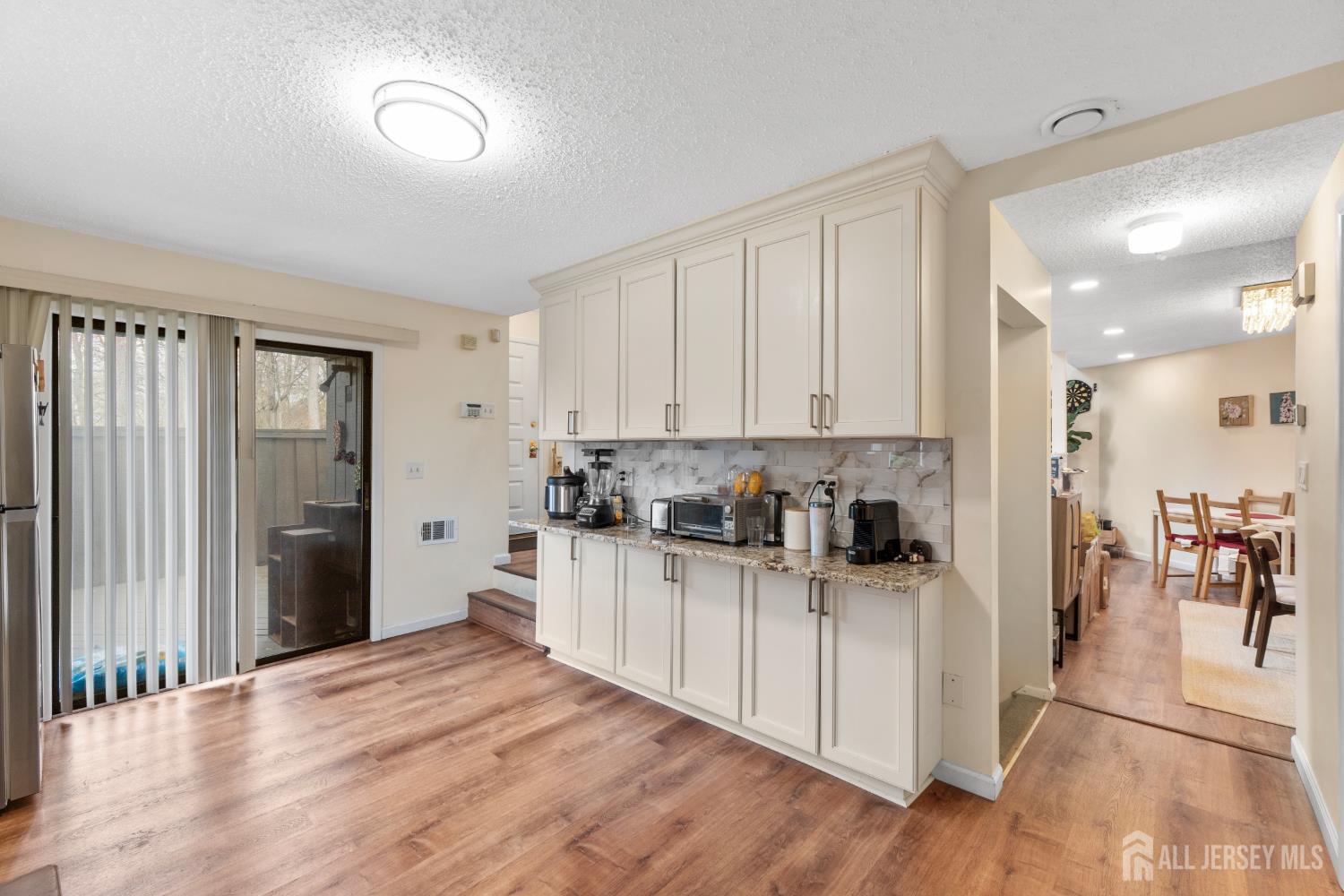 272 Westgate Drive Edison, NJ 08820 - Photo 22 of 47 a kitchen with a refrigerator and a view of living room