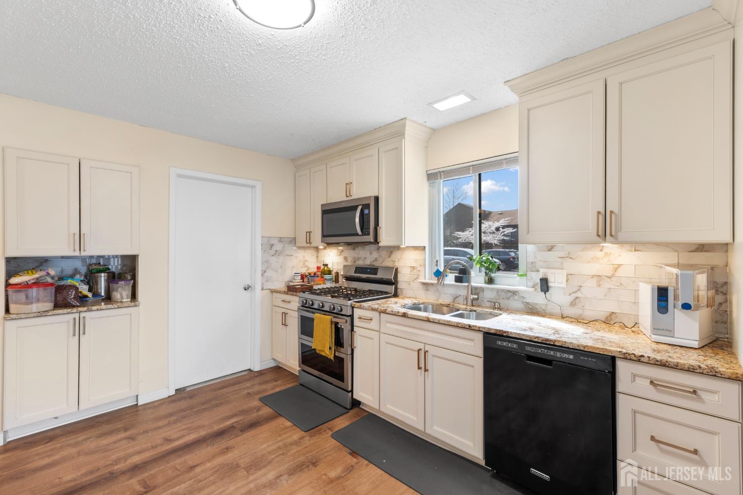 272 Westgate Drive Edison, NJ 08820 - Photo 24 of 47 a kitchen with a sink cabinets and stainless steel appliances
