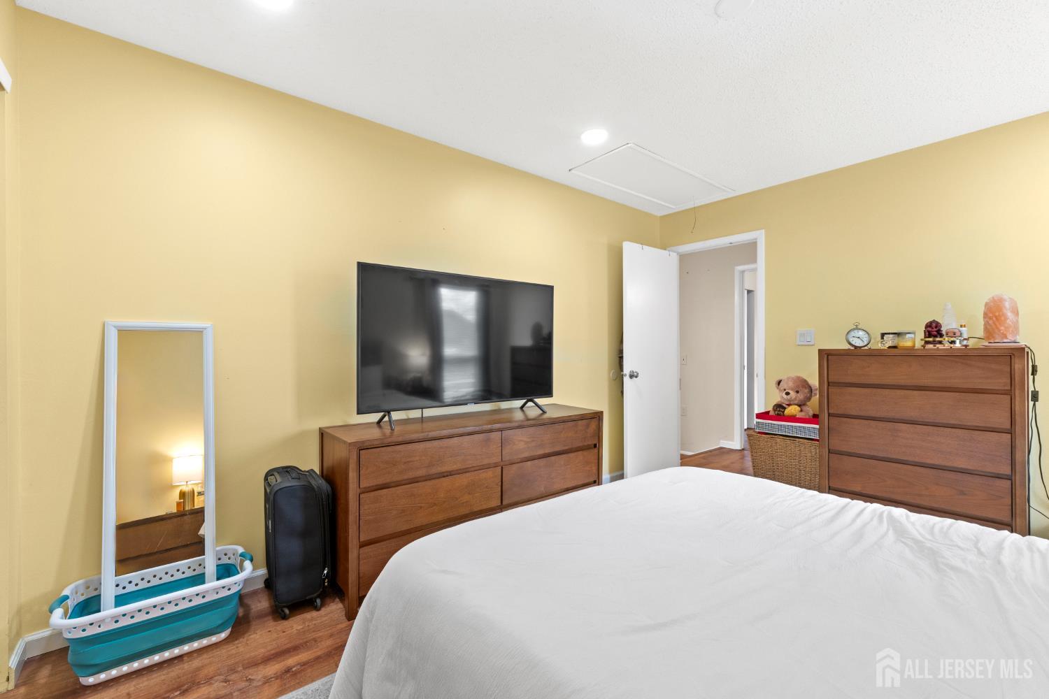 272 Westgate Drive Edison, NJ 08820 - Photo 30 of 47 a bedroom with a bed and a flat screen tv
