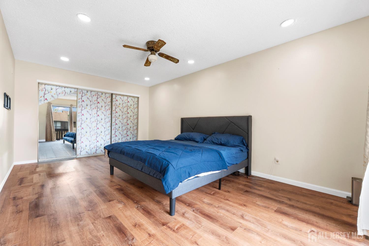 272 Westgate Drive Edison, NJ 08820 - Photo 33 of 47 a bedroom with a large bed and wooden floor