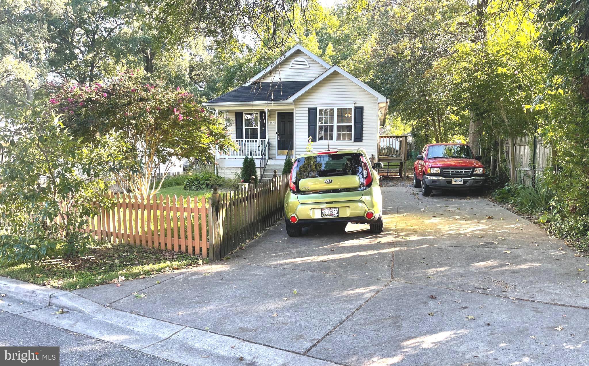 a view of a house with a cars parked in front of it