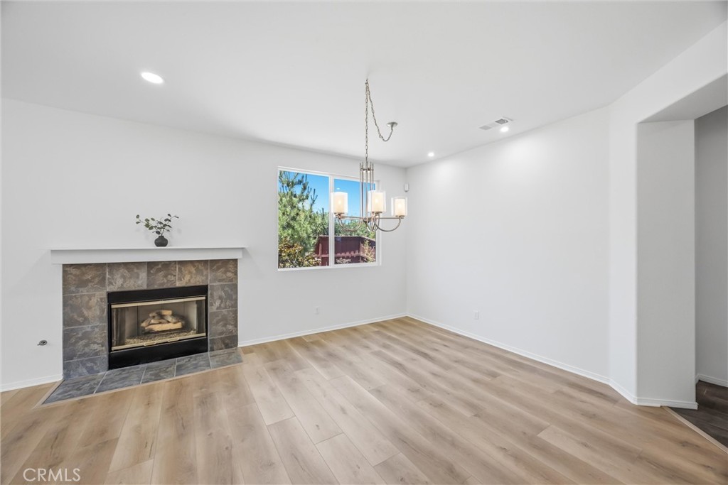 8710 Windmill Place Riverside, CA 92508 - Photo 20 of 66 a view of an empty room with a fireplace and a window