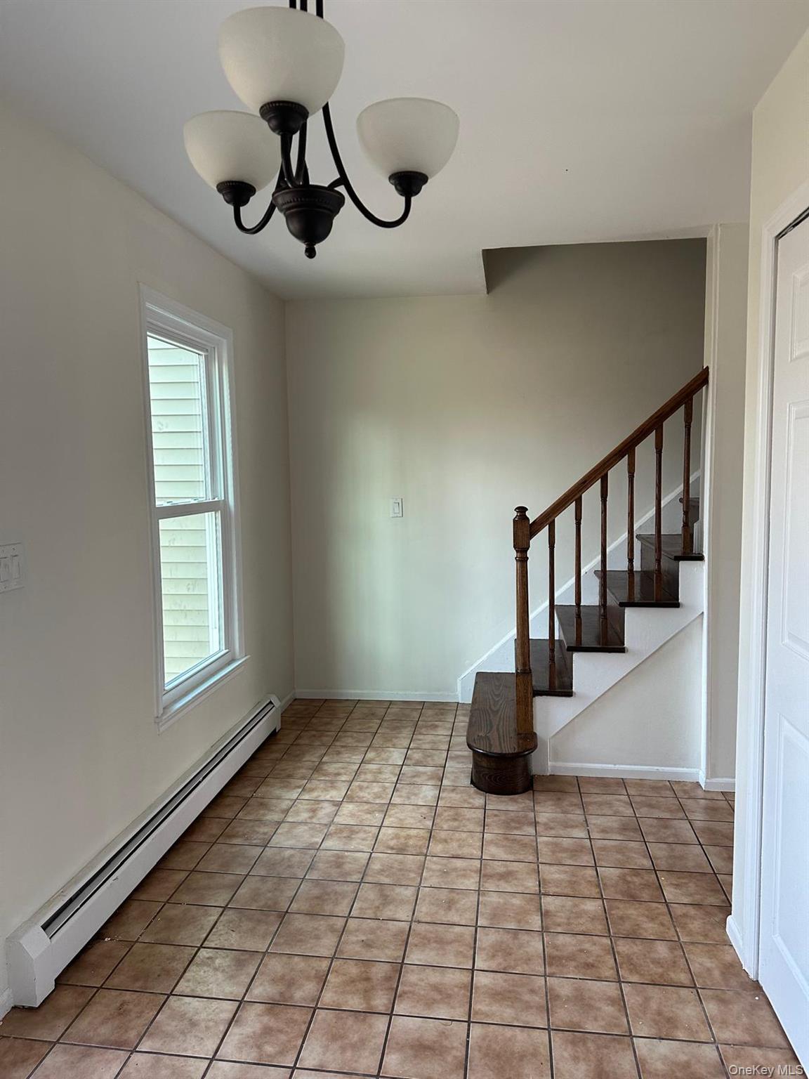 a hallway with a window and wooden floor