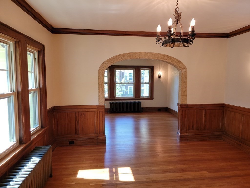 133 Fairview Avenue, Unit 133 Belmont, MA 02478 - Photo 13 of 33 a view of a livingroom with wooden floor and stairs