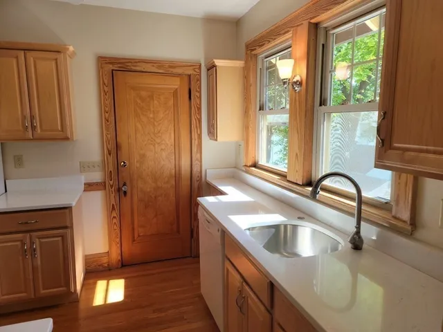 a kitchen with a sink a counter top space and a window