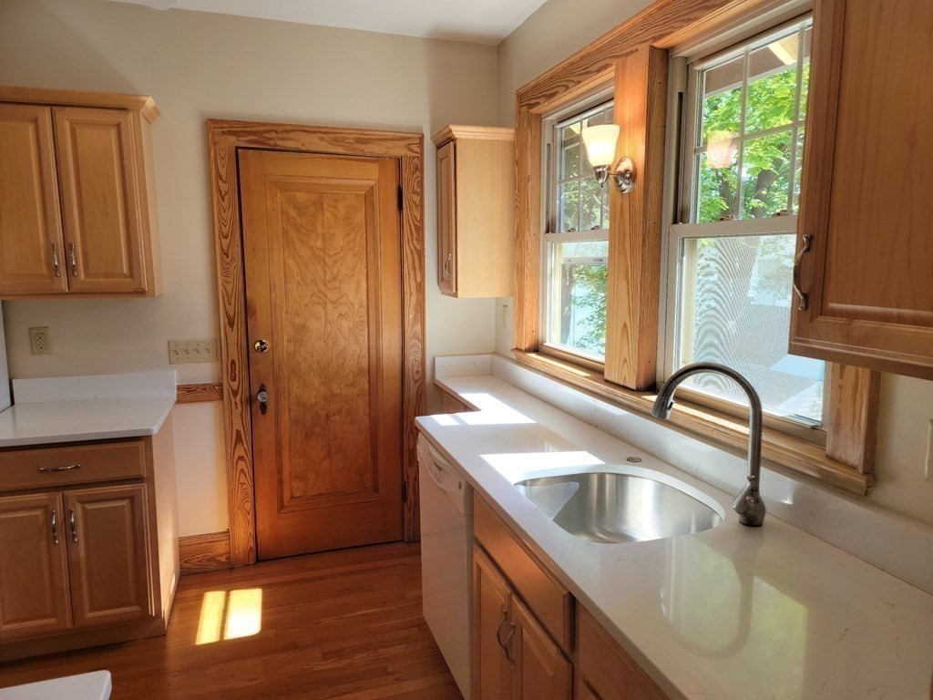 133 Fairview Avenue, Unit 133 Belmont, MA 02478 - Photo 17 of 33 a kitchen with a sink a counter top space and a window