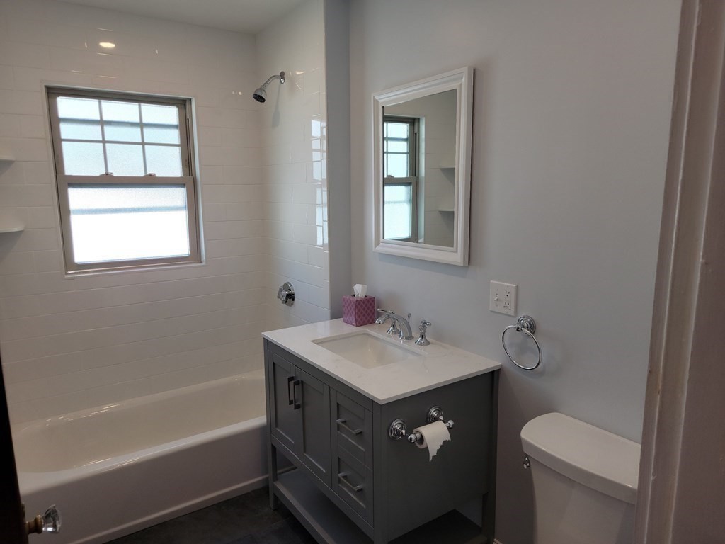 133 Fairview Avenue, Unit 133 Belmont, MA 02478 - Photo 21 of 33 a bathroom with a sink toilet vanity and bathtub