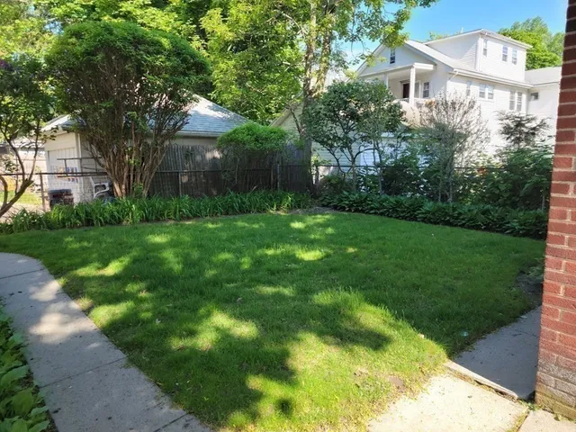a view of a house with a backyard