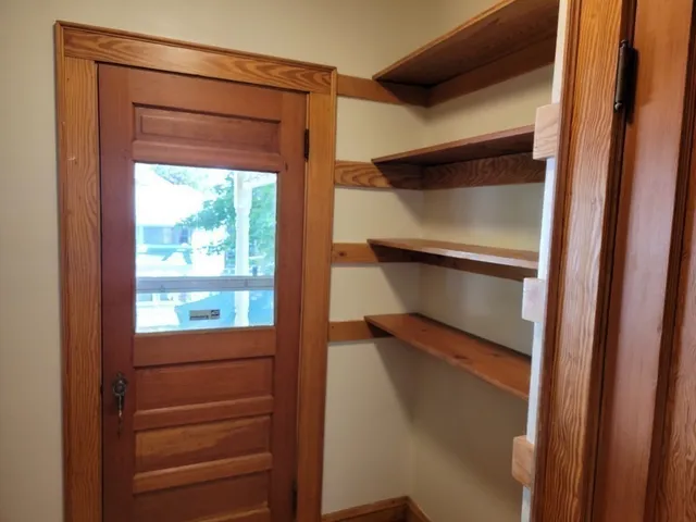 a view of walk in closet with empty racks