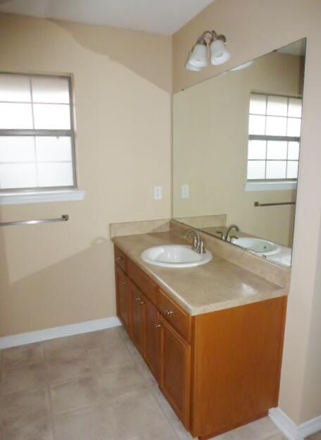 2829 Shoni Drive Navarre, FL 32566 - Photo 11 of 33 a bathroom with a granite countertop sink and a mirror
