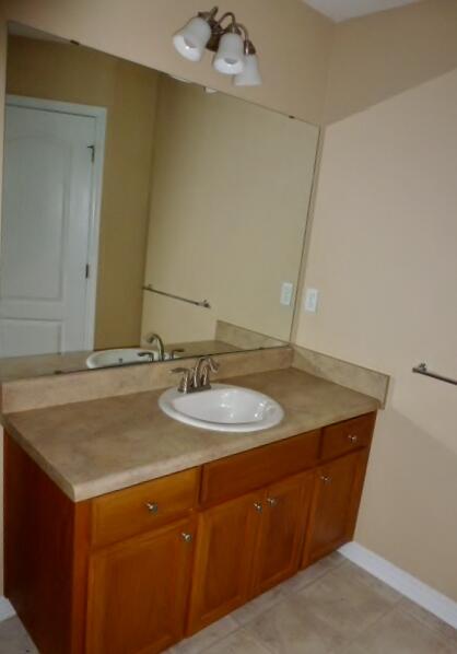 2829 Shoni Drive Navarre, FL 32566 - Photo 14 of 33 a bathroom with a granite countertop sink and a mirror