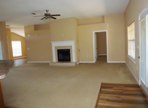 2829 Shoni Drive Navarre, FL 32566 - Photo 15 of 33 a view of an empty room with a fireplace and a window