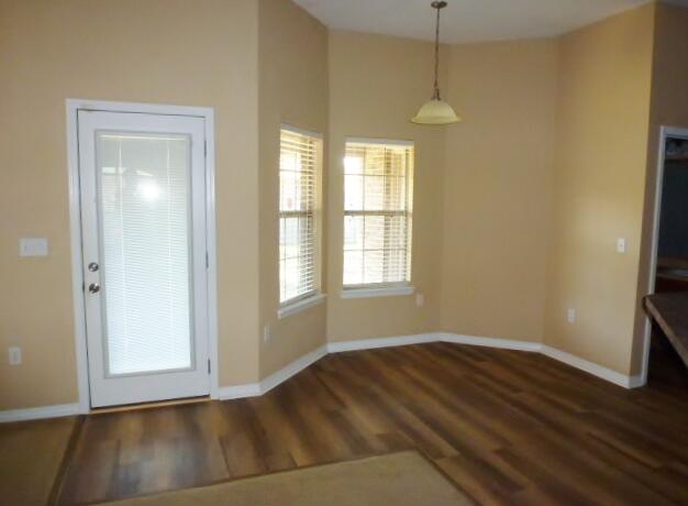 2829 Shoni Drive Navarre, FL 32566 - Photo 16 of 33 a view of a room with wooden floor and windows