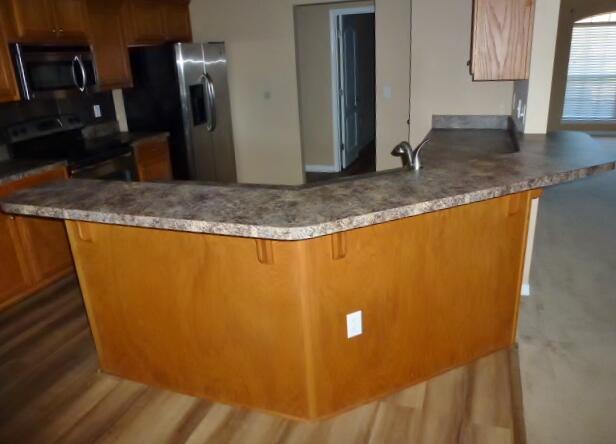 2829 Shoni Drive Navarre, FL 32566 - Photo 18 of 33 a view of a kitchen with stainless steel appliances granite countertop cabinets and a counter top