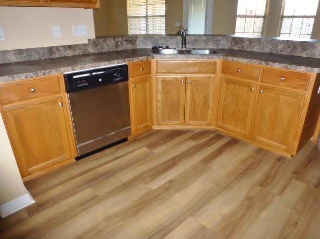 2829 Shoni Drive Navarre, FL 32566 - Photo 19 of 33 a view of a kitchen with granite countertop cabinets and sink