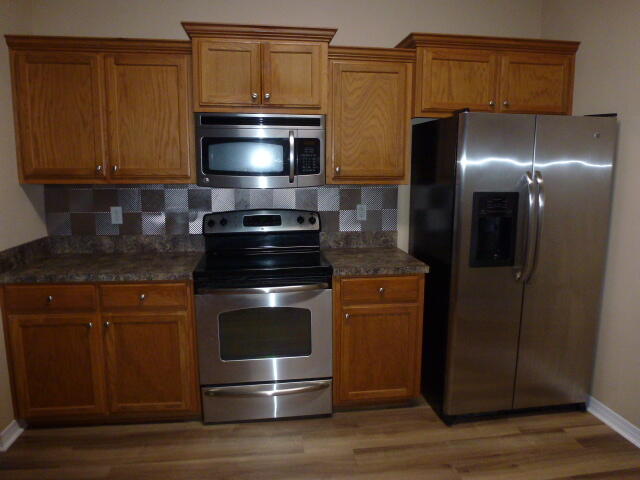 2829 Shoni Drive Navarre, FL 32566 - Photo 20 of 33 a kitchen with a stove and a microwave