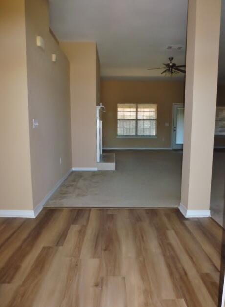 2829 Shoni Drive Navarre, FL 32566 - Photo 2 of 33 a view of empty room with wooden floor and fan