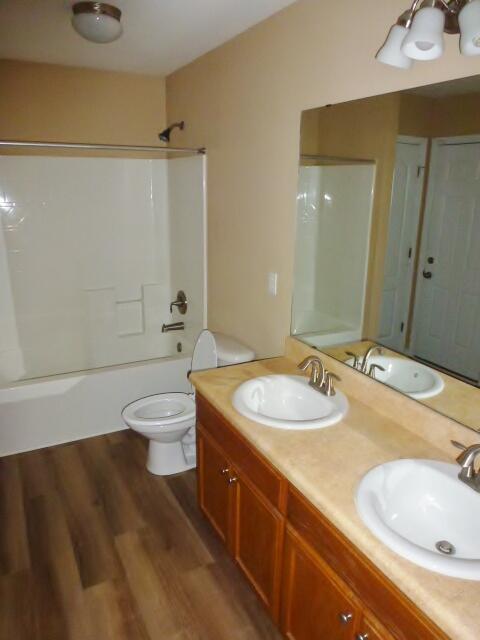 2829 Shoni Drive Navarre, FL 32566 - Photo 22 of 33 a bathroom with a granite countertop sink a toilet and shower