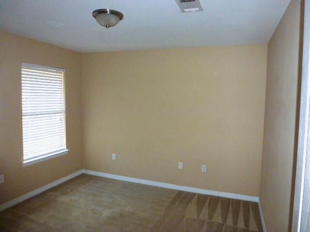 2829 Shoni Drive Navarre, FL 32566 - Photo 23 of 33 an empty room with windows