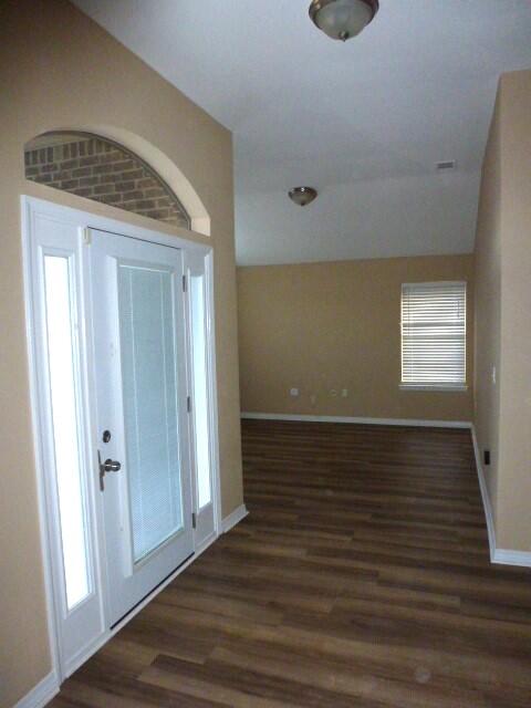 2829 Shoni Drive Navarre, FL 32566 - Photo 3 of 33 a view of an empty room with wooden floor and a window