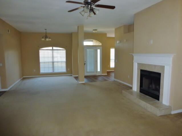 2829 Shoni Drive Navarre, FL 32566 - Photo 6 of 33 an empty room with a fireplace and fan