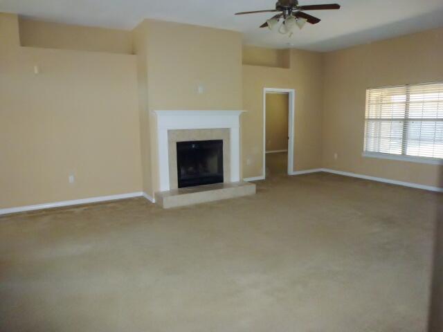 2829 Shoni Drive Navarre, FL 32566 - Photo 8 of 33 an empty room with a fireplace and fan