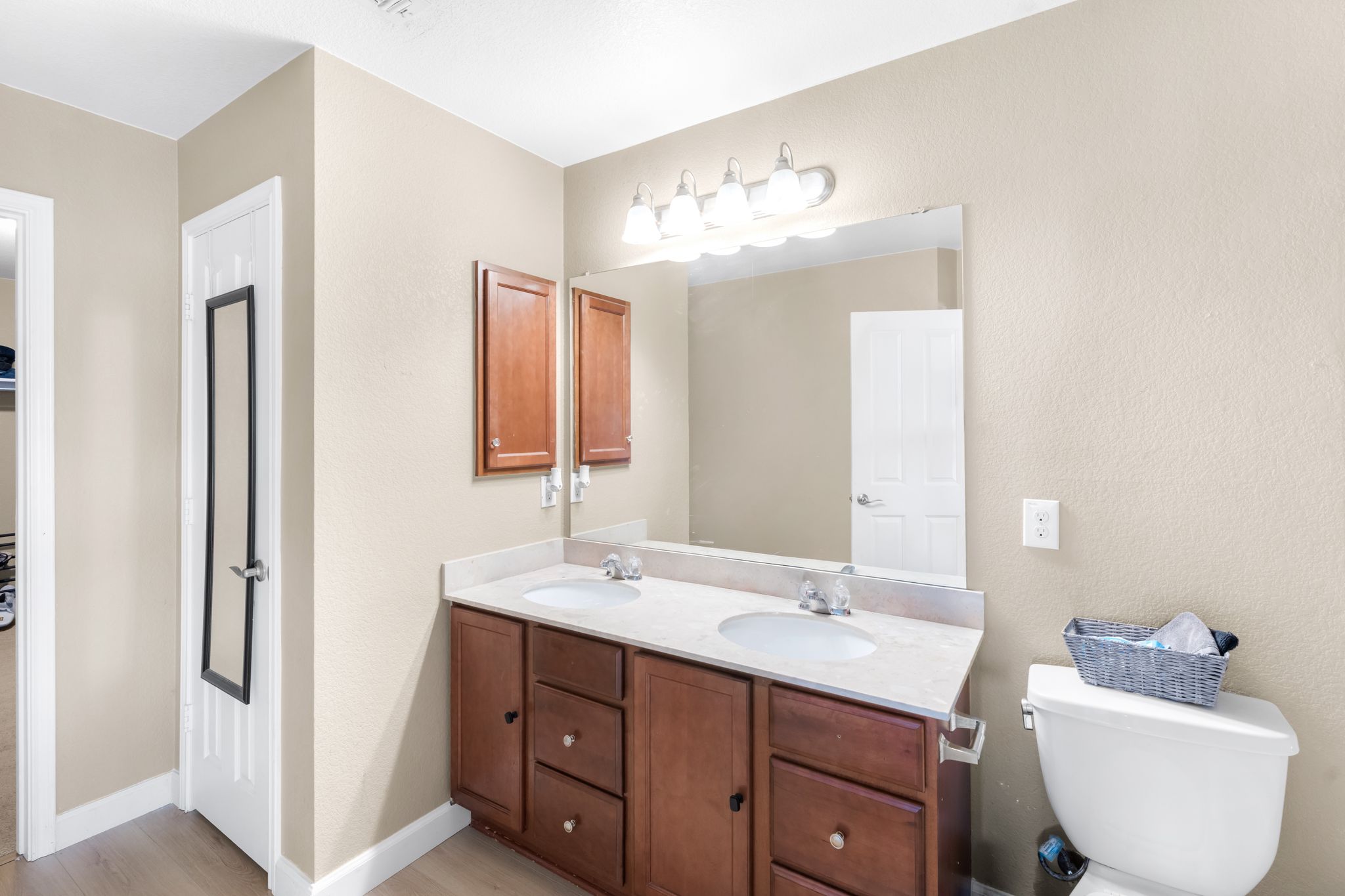 6708 Glebe Path Austin, TX 78754 - Photo 26 of 35 Double vanity with ample storage and a spacious mirror creates a highly functional primary bathroom.
