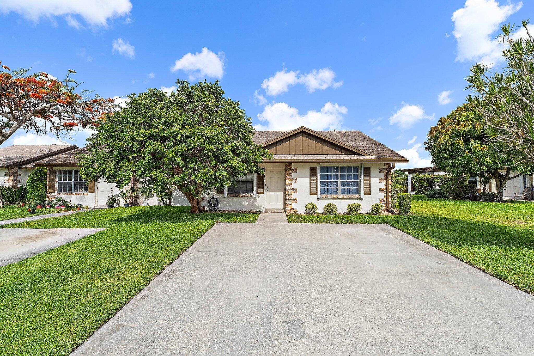 109 Doe Trail Jupiter, FL 33458 - Photo 1 of 26 a view of a house with a yard and porch