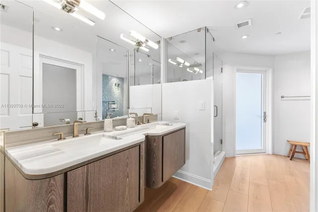 a bathroom with a sink double vanity and a mirror