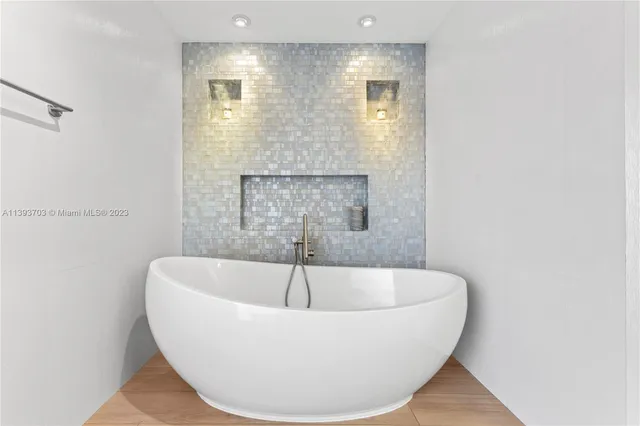 a white bath tub sitting in a bathroom